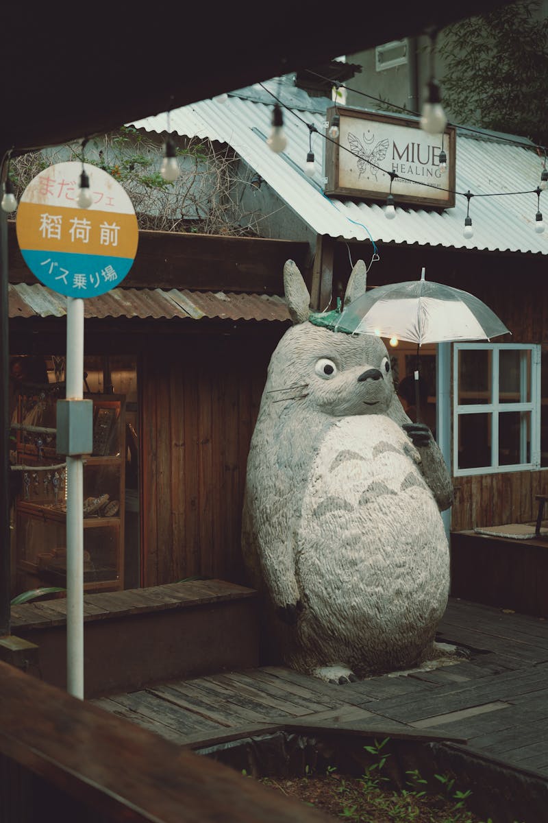 Charming street scene with Totoro statue in Dalat, Vietnam capturing local ambiance.