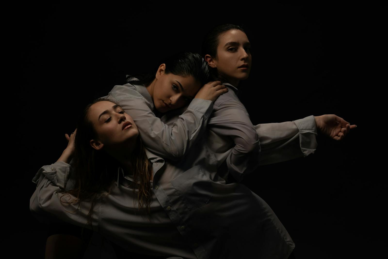 three women posed artistically, close to each other