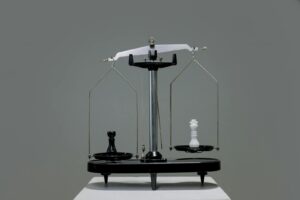 Chess pieces balanced on a scale depicting equality or strategy in decision making.