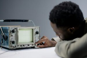 A person holding white and gray digital device